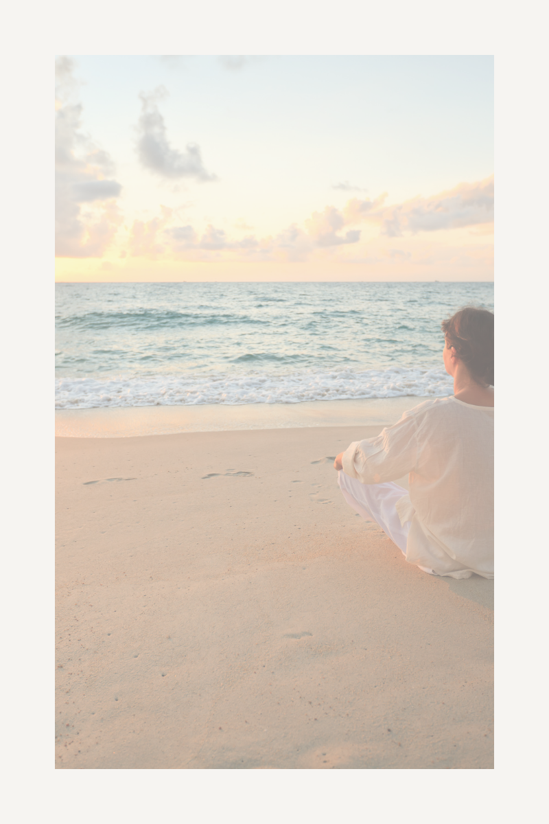 A woman finding peace looking out over the calming water