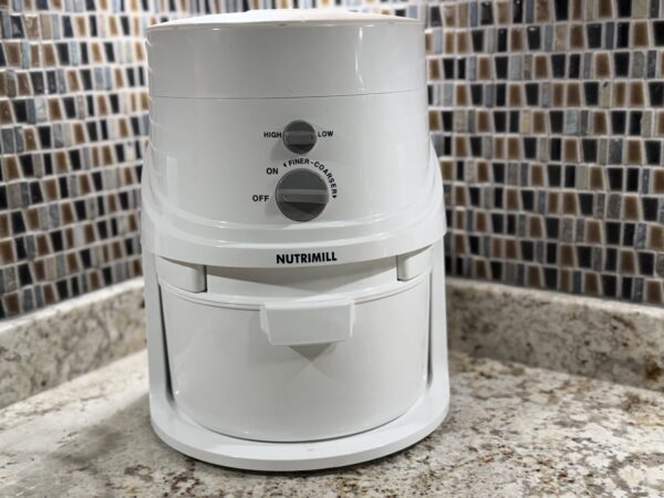 NutriMill Classic Grain Mill sitting on a kitchen counter, ready for grinding fresh flour